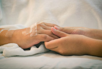 A person holding their hand in the hospital