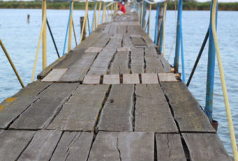 A wooden dock with many steps leading to the water.